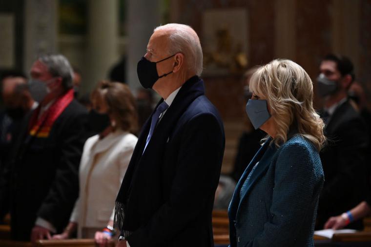 President-elect Joe Biden (C) and incoming First Lady Jill Biden attend Mass at the Cathedral of St. Matthew the Apostle in Washington, DC, on January 20, 2021.