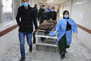 An injured man is rushed to the emergency ward of a hospital following a twin suicide bombing on a bustling commercial street in the heart of the Iraqi capital of Baghdad on Jan. 21. The attack killed at least 32 people and wounded more than 110 others, Iraq's health ministry said. The ministry said the first suicide bomber had rushed into the market and claimed to feel sick, so that people would gather around him. He then detonated his explosives.