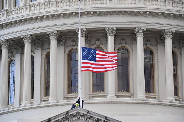 A U.S. flag is raised after the inauguration of Joe Biden as the 46th U.S. president on Jan. 20 at the U.S. Capitol in Washington.