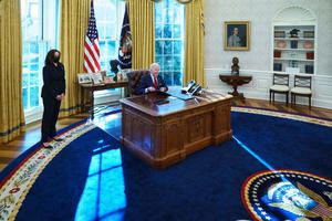 US President Joe Biden, with Vice President Kamala Harris (L), signs executive orders on health care, in the Oval Office of the White House in Washington, DC, on Jan. 28, 2021. The orders included rescinding the Mexico City Policy that barred tax payer dollars from oversees groups that promote abortion.