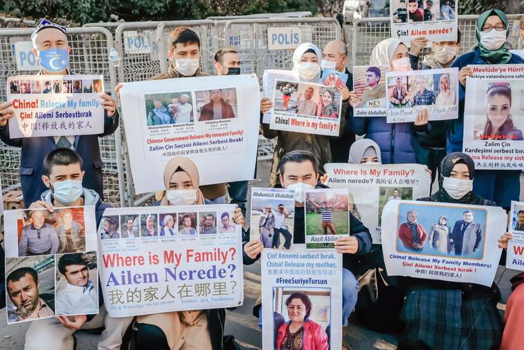 Members of the Muslim Uyghur minority hold placards as they demonstrate in front of the Chinese consulate on Dec. 30, 2020, in Istanbul, to ask for news of their relatives and to express their concern after China announced the ratification of an extradition treaty with Turkey.