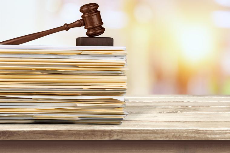 A gavel sits on top of court documents.