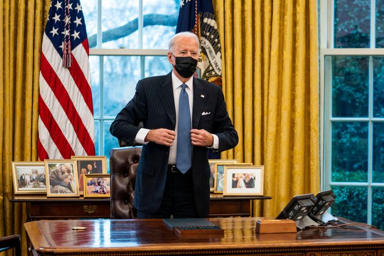 President Joe Biden stands after signing an executive order in the Oval Office of the White House on January 25, 2021 in Washington, DC. President Biden signed an executive order repealing the ban on transgender people serving openly in the military.