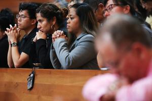 A family prays during Ash Wednesday Mass at the Cathedral of Our Lady of the Angels on Feb. 26, 2020, in Los Angeles, California.