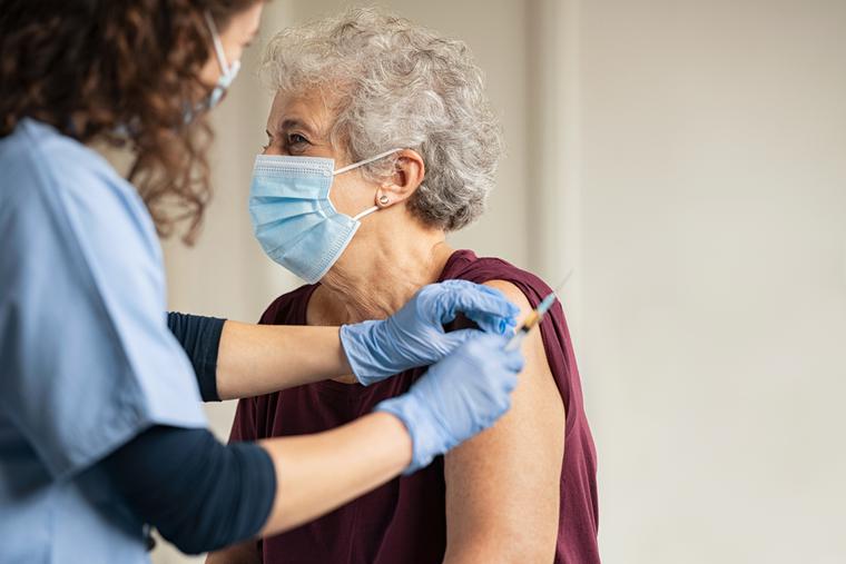 An elderly patient receives the COVID vaccine.