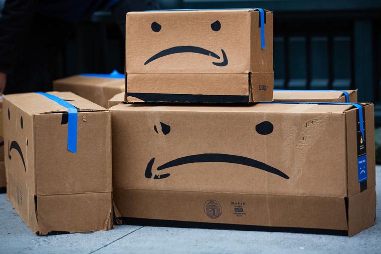 Cardboard boxes made to resemble Amazon packages are seen during a labor protest outside the home of Amazon CEO Jeff Bezos in New York on Dec. 2.