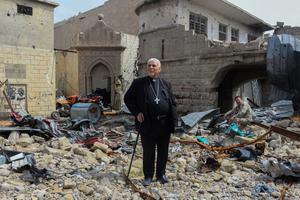 Father John Botros Moshi, the Syriac Catholic Archbishop of Mosul, Kirkuk, and the Kurdistan Region, stands in the rubbles of the Tahra church in Mosul on April 29, 2018. - The church, established during the seventh century, was destroyed by bombings when the regime was fighting jihadists in this area.