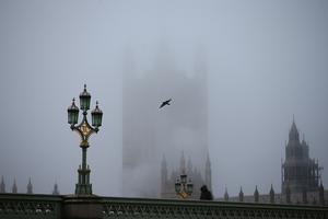 Fog settles over the Houses of Parliament on Dec. 28 in London, shortly after the UK government nixed a plan to allow household mixing in England for five days over Christmas.