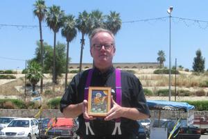 Father Benedict Kiely is shown standing opposite the tomb of Jonah in Mosul (Nineveh), Iraq, in July 2019. He holds an icon of the prophet Jonah. Father Kiely makes frequent trips to Iraq to help the beleaguered Christians there.