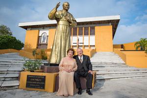 A couple sits together in front of a statue of Pope St. John Paul II at Maria Auxiliadora church in Monterrey, Mexico, on Jan. 18, 2020 — their 50th wedding anniversary.