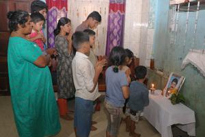 The family of Antony Akkaraparambil, who died tragically Feb. 12, prays together on Feb. 20 at their home in Adat.