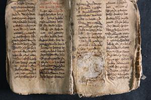 A historic Aramaic prayer manuscript restored after descration by the Islamic State. During his Iraq visit, Pope Francis returned the manuscript to the Catholic church where it was once held.