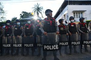 Police create a barrier during protests in Burma.
