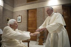 Pope Francis greets Benedict XVI after the creation of new cardinal Nov. 28, 2020.