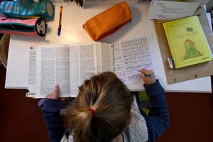 A child does his homework in Marseille, southern France, on April 6, 2021, as schools are closed in France as part of a lockdown to fight the spread of the COVID-19 pandemic.