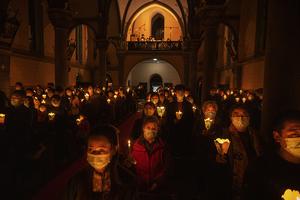 Chinese Catholics hold candles during the Easter Vigil Mass at a church in Beijing on April 3.