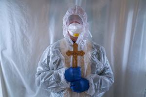 Father Stephan, a Ukrainian Greek Catholic Church priest, wearing a special suit to protect himself against coronavirus, stands, after visiting patients with COVID-19 at an intensive care unit of the emergency hospital in Lviv, Western Ukraine, Saturday, Jan. 9, 2021. Father Stephan, a Ukrainian Greek Catholic Church priest, wearing a special suit to protect himself against coronavirus, stands, after visiting patients with COVID-19 at an intensive care unit of the emergency hospital in Lviv, Western Ukraine, Saturday, Jan. 9, 2021.