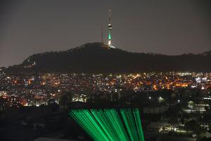 Greenpeace activists project a laser message saying “Leaders Save Earth, Save Us” Wednesday in Seoul, South Korea. President Biden has invited 40 world leaders, including Pope Francis, to participate in the Leaders Summit on Climate and is hoping to reach deals with some of the world’s largest greenhouse gas emitters.