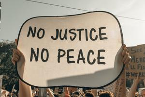 Protesters in Minneapolis hold signs before the verdict in the case against Derek Chauvin was decided.