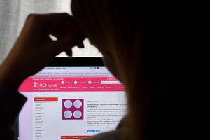 A woman looks at a website offering the abortion pill (RU-486) from Mifepristone displayed on a computer  in Arlington, Virginia.