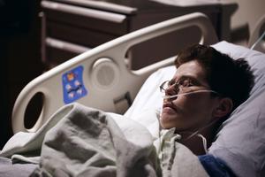 A patient declared brain dead sleeps in a hospital bed.