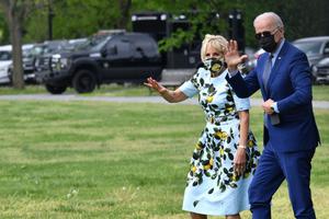 President Joe Biden and First Lady Jill Biden wave as they arrive to board Marine One from the Ellipse in Washington, DC, on April 29, 2021. - President Biden travels to Georgia to mark his first 100 days in office.