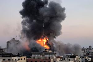 Black smoke billows after an Israeli airstrike on Gaza City targeted the Ansar compound, linked to the Hamas movement, in the Gaza Strip on May 14. Israel targeted Gaza and deployed extra troops to the border as Palestinians fired barrages of rockets back, with the death toll in the enclave on the fourth day of conflict climbing to more than 100.