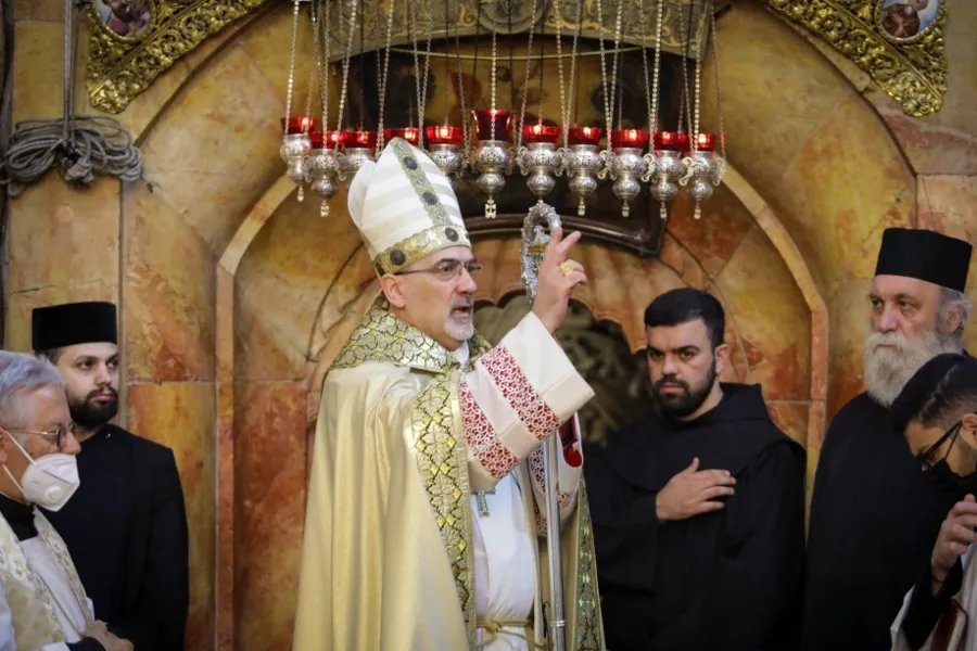 Patriarch Pierbattista Pizzaballa blesses the congregation at the Church of the Holy Sepulchre in Jerusalem on April 4, 2021.