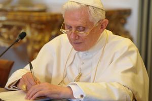 Pope Benedict XVI is shown writing on Aug. 28, 2010.