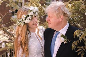 Prime Minister Boris Johnson poses with his wife Carrie Johnson in the garden of 10 Downing Street following their wedding at Westminster Cathedral, May 29, 2021 in London, England.
