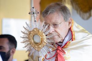 Cardinal George Pell holds the monstrance with the Blessed Sacrament during the annual Eucharistic procession at the Angelicum in Rome on May 13.