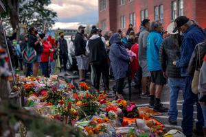 People gather outside the former Kamloops Indian Residential School as they welcome a group of runners from the Syilx Okanagan Nation taking part in The Spirit of Syilx Unity Run, following the discovery of the remains of 215 children buried near the facility, in Kamloops, British Columbia, Canada, on June 5, 2021.