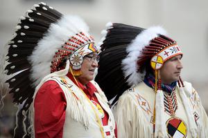 Two Native Americans faithful wearing traditional regalia stand during Pope Francis weekly general audience in St Peter's square at the Vatican on April 27, 2016.