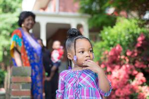 A young girl looks out as her foster mother, Sharonell Fulton, watches her from a distance in Philadelphia, Pa.