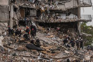 Search-and-rescue teams look for possible survivors in the partially collapsed 12-story Champlain Towers South condo building on June 28 in Surfside, Florida.