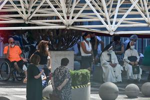 Bystanders including Dominican nuns gather to pray outside the Policlinico A. Gemelli Hospital in Rome on July 6, 2021, where Pope Francis arrived on July 4, to undergo a scheduled surgery.