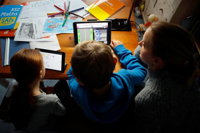 8-year-old Harriet Mumby and 10-year-old Oscar Mumby (daughter and son of the photographer) are homeschooled by their mother Jo Mumby on Jan. 27 in Cuckfield, England.