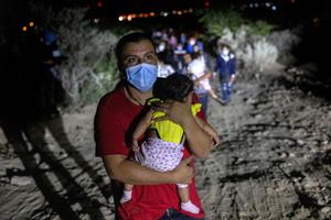 Immigrants walk towards a U.S. Border Patrol checkpoint after they crossed the Rio Grande from Mexico on August 14, 2021 in Roma, Texas.