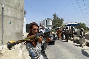 A Taliban fighter holds RPG rocket propelled as he stands guard with others at an entrance gate outside the Interior Ministry in Kabul on August 17, 2021.