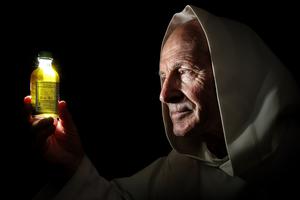 A Carthusian inspects a sample of chartreuse.