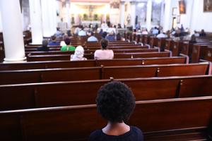 Parishioners sit during Sunday Mass at St. Augustine Catholic Church on August 15, 2021 in New Orleans, Louisiana. Parishioners wore face coverings during Mass as part of COVID-19 protocols inside the historic church which is recognized as the oldest Black Catholic parish in the country.