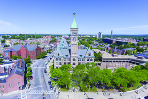 An aerial view of City Hall and the downtown district of Lowell, Massachusetts, is shown. One student at the University of Massachusetts at Lowell, Hunter Harris, and a student at the University of Massachusetts at Boston sued the state-college system when their appeal for a religious exemption to the COVID-19 vaccination was denied.
