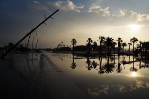 A road is partially covered in floodwater in the wake of Hurricane Ida on Sept. 3, 2021, in Grand Isle, Louisiana. Ida made landfall as a Category 4 hurricane five days before in Louisiana and brought flooding, wind damage and power outages along the Gulf Coast.