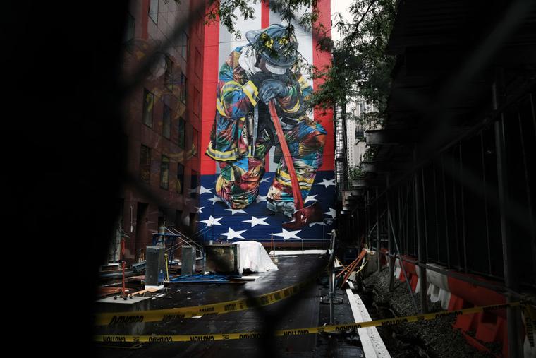 A mural to fallen firefighters is seen covered by scaffolding in Manhattan on Sept. 9 in New York City. New York City and much of the nation are preparing for the 20th anniversary of the terrorist attacks in both New York City and Washington D.C.