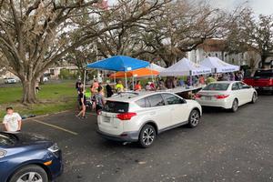 Cars line up to receive food and supplies at St. Charles Borromeo Church in Destrehan, Louisiana, in the days following Hurricane Ida.
