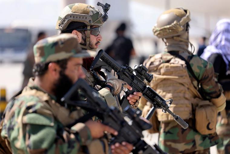 Fighters of the Taliban Badri 313 military unit stand guard at the airport in Kabul on  September 14, 2021.