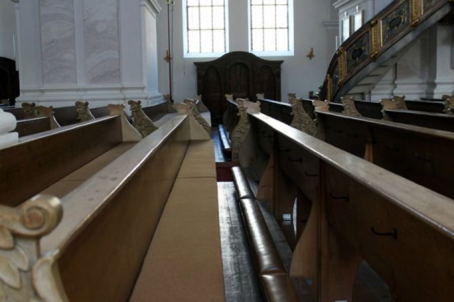 Church pews in an empty church.