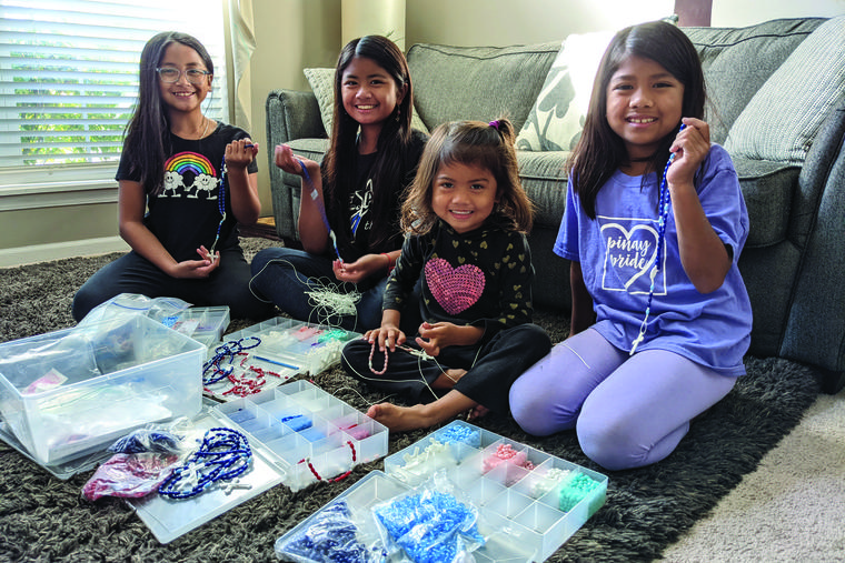 Abigail, Marigrace, Patricia and Josephine Quicho enjoy making rosaries.