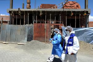 Health personnel of the Bolivian Health Ministry walk at Santa Rosa neighborhood to vaccinate people against COVID-19 home by home in El Alto, Bolivia, on September 17, 2021.