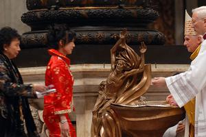 Pope Benedict XVI prepares to baptize a woman from China during the Easter Vigil Mass in the Basilica of St. Peter, April 7, 2007, at the Vatican.
